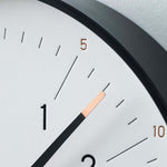 Close-up of Essent Clock, White, showcasing modern, elegant design with clear typeface and stylish foil stamping.