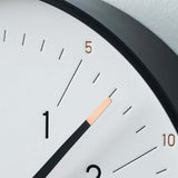 Close-up of Essent Clock, White, showcasing modern, elegant design with clear typeface and stylish foil stamping.