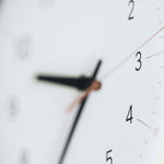 Close-up of the Essent Clock face showing clear numerals and hands, embodying modern elegance and high-quality craftsmanship.