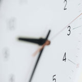 Close-up of the Essent Clock face showing clear numerals and hands, embodying modern elegance and high-quality craftsmanship.