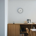 Essent Clock in a modern space, showcasing elegant design and clear time display against a minimalist backdrop.