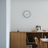 Essent Clock in a modern space, showcasing elegant design and clear time display against a minimalist backdrop.