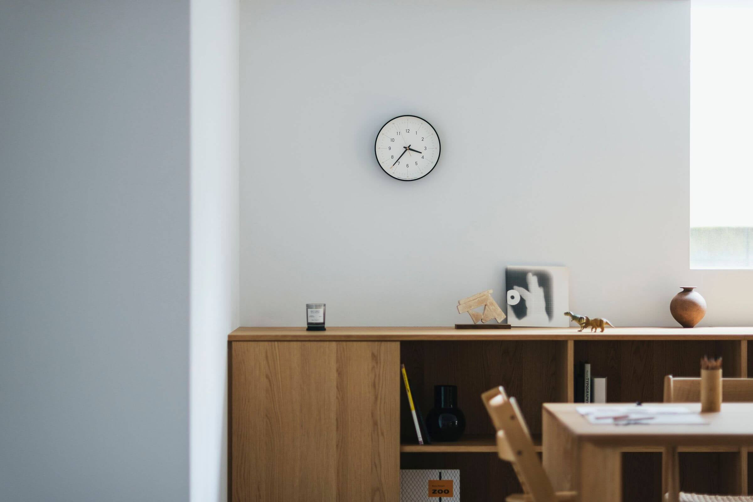 Essent Clock in a modern space, showcasing elegant design and clear time display against a minimalist backdrop.