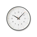 Essent Clock in white, showcasing modern design with clear numerals and stylish clock hands.