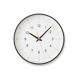 Essent Clock in white, showcasing modern design with clear numerals and stylish clock hands.