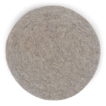 Round felt wool seat cushion in soft gray, handmade from 100% New Zealand wool, ideal for extra comfort on hard surfaces.