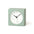 Light green square clock with a white face on a white background