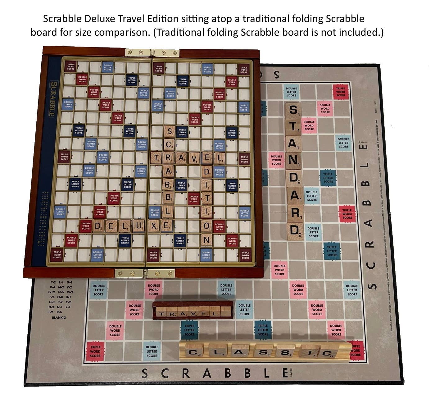 Scrabble Deluxe Travel Edition game board on top of a traditional folding Scrabble board for size comparison.