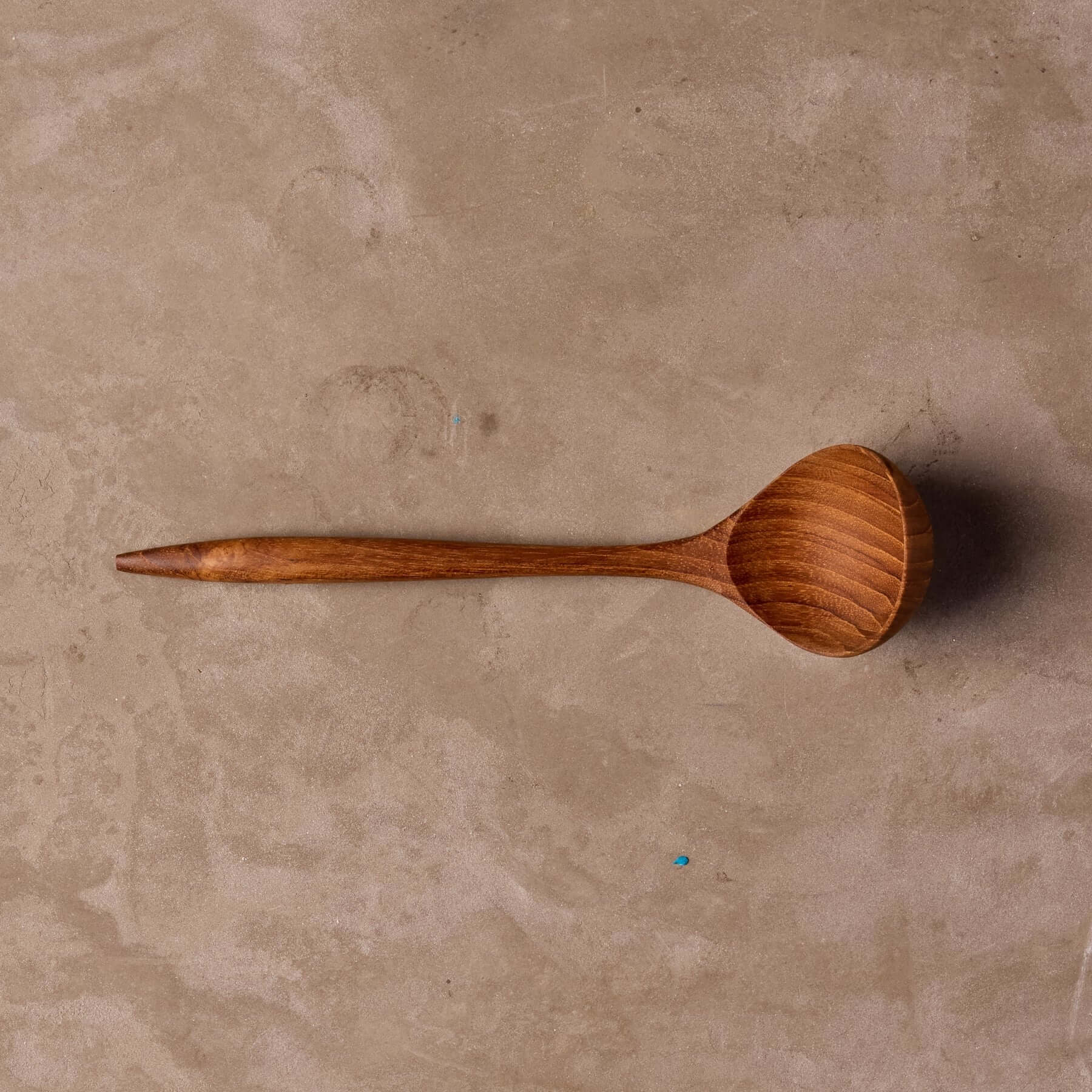 Teak sauce ladle on table