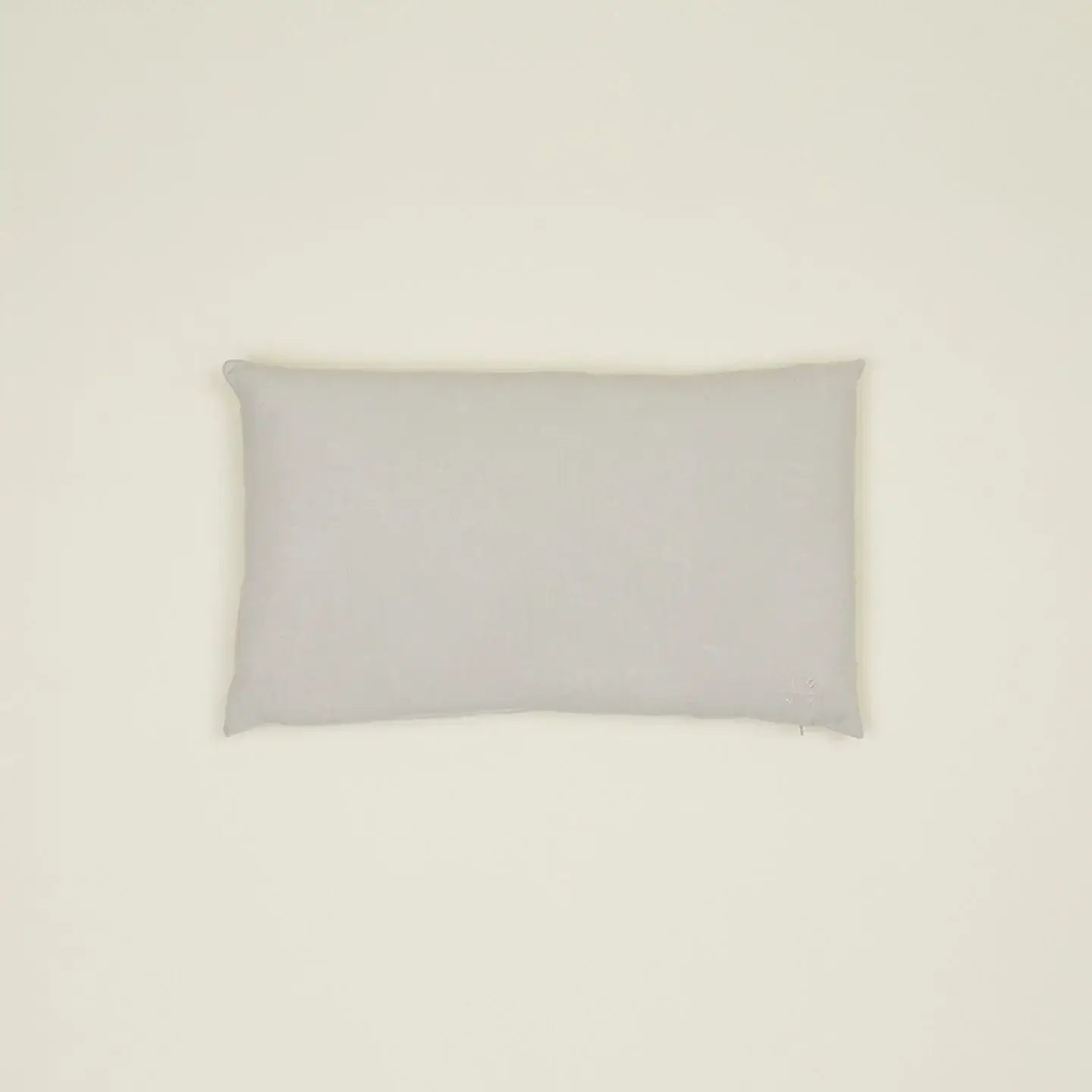 Simple light gray linen pillow, made from high-quality Belgian linen, featuring a cozy feel and oversized down insert.