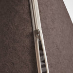 Close-up of a zipper on brown pet bed.