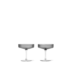 A pair of mouth-blown gray glass champagne saucers with a rippled surface design.