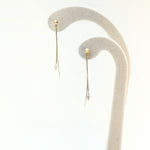 Hanabi Marquise Diamond Earrings displayed on a white velvet earring stand.