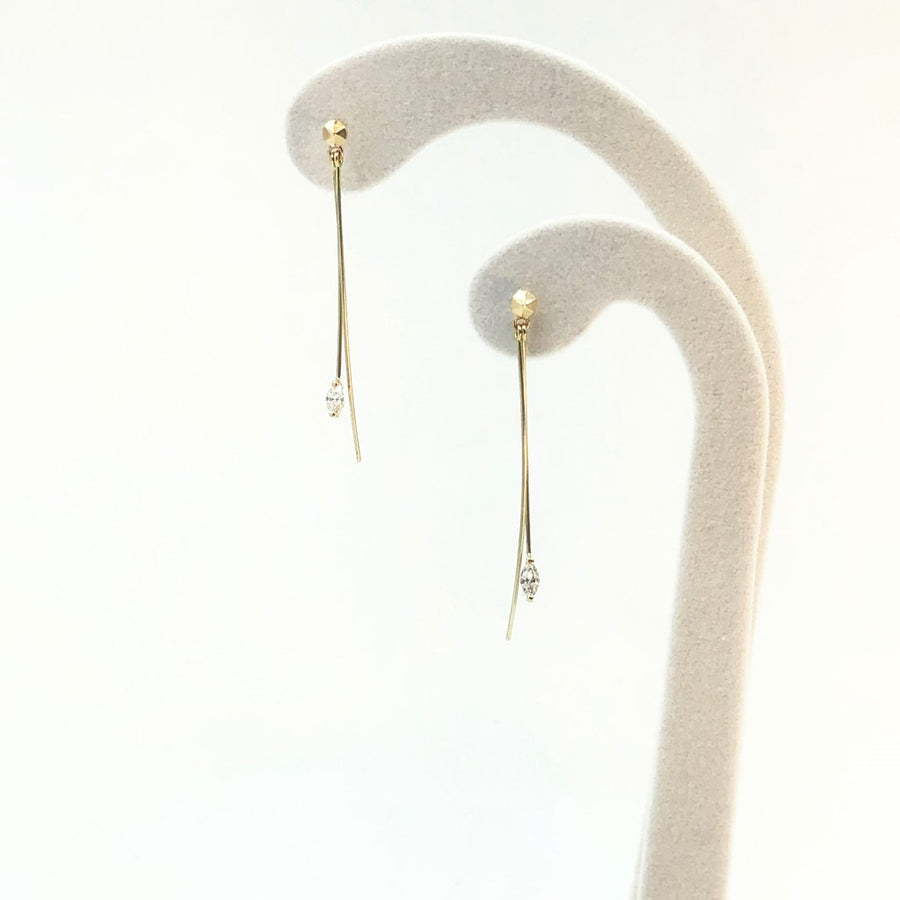 Hanabi Marquise Diamond Earrings displayed on a white velvet earring stand.
