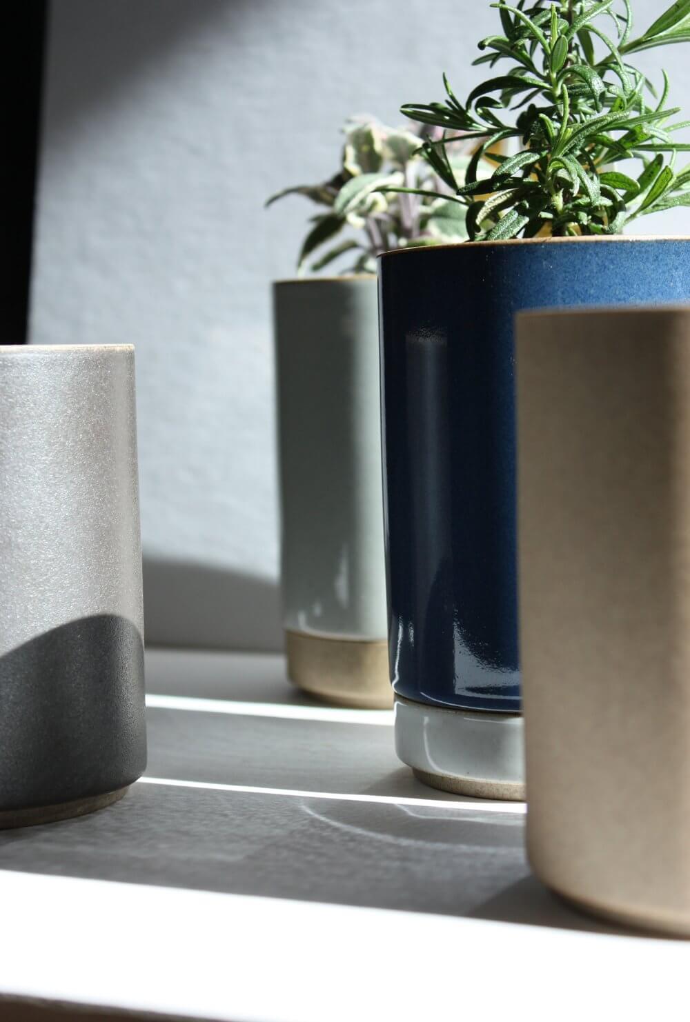 Hasami Porcelain small planters in glossy grey and dark blue with plants, showcasing modern and minimalist design.
