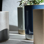 Hasami Porcelain small planters in glossy grey and dark blue with plants, showcasing modern and minimalist design.
