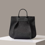A timeless tote bag, Franke-collection by Graf Lantz, from Merino Wool in charcoal standing on a white base, front view