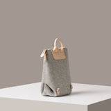 A light grey Bedford Merino Wool Felt Midi Backpack on a white base displayed in a side-view
