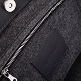 Interior view of Frankie Merino Wool Tote featuring a zippered felt pocket, black leather trim, and nickel hardware, highlighted in detail