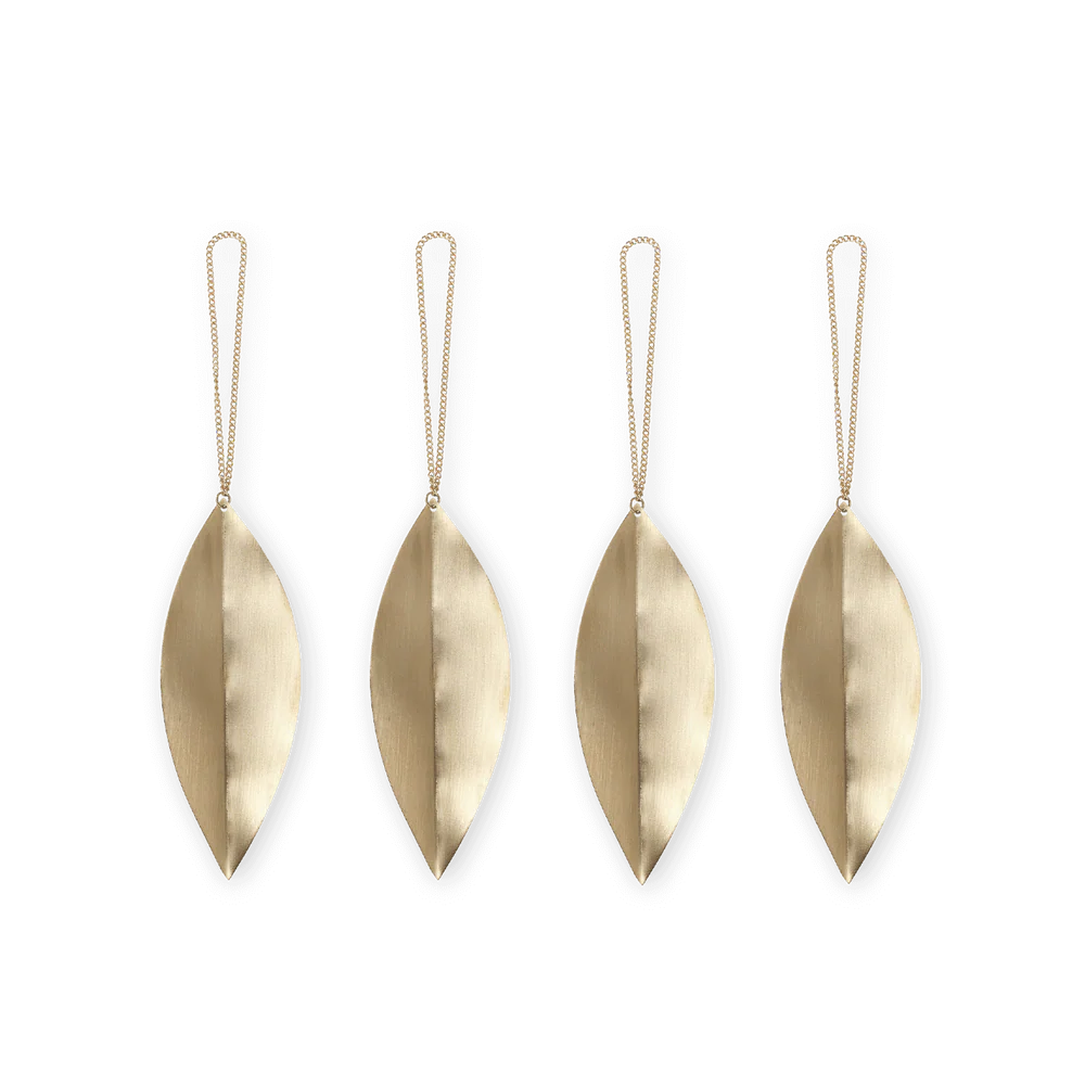 Four brass leaf-shaped ornaments with strings on a white background