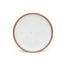A dinner sized ceramic plate in a cool white color featuring iron speckles and an unglazed rim.