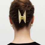 Woman wearing Midi Heirloom Claw in Green Tortoise, double-walled hair claw clip.