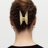 Woman wearing Midi Heirloom Claw in Green Tortoise, double-walled hair claw clip.