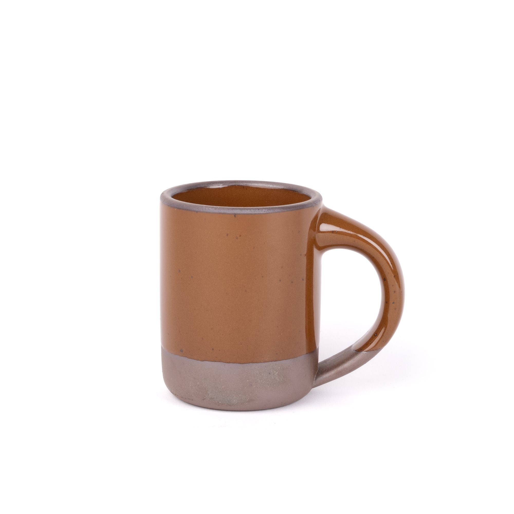 A medium sized ceramic mug with handle in a glossy caramel brown color featuring iron speckles and unglazed rim and bottom base.