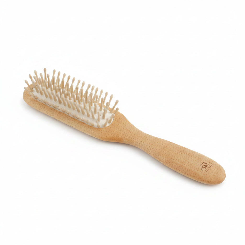 A wooden hairbrush with a light natural wood handle and bristles, shown on a plain white background.
