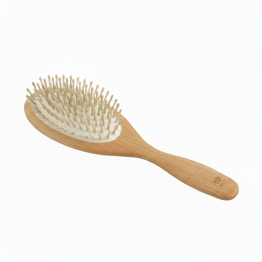 A wooden hairbrush with a light natural wood handle and head, beige bristles, and a white inner pad, shown on a plain white background.