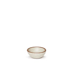 A tiny rounded ceramic bowl in a warm, tan-toned, off-white color featuring iron speckles and an unglazed rim