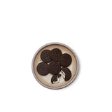 Oreos on a dessert sized ceramic plate in a warm pale brown color featuring iron speckles and an unglazed rim.