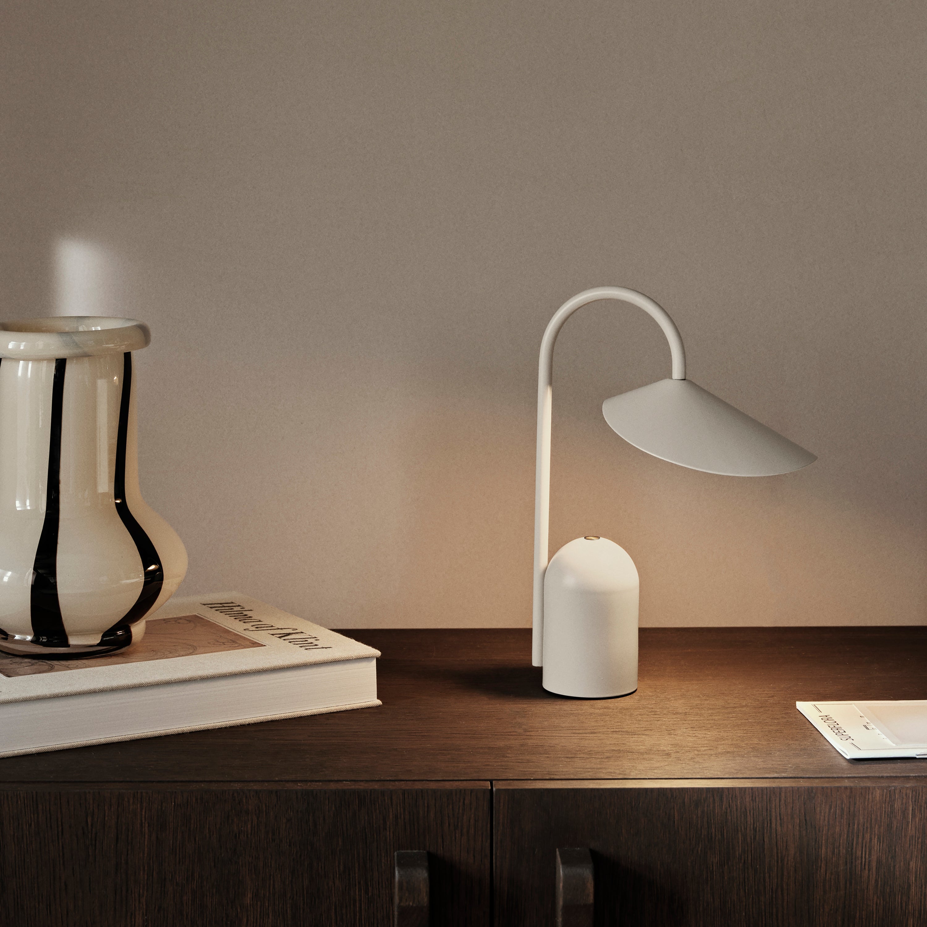 White lamp on a wooden surface with a neutral background