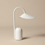 Minimalist white table lamp on a beige background