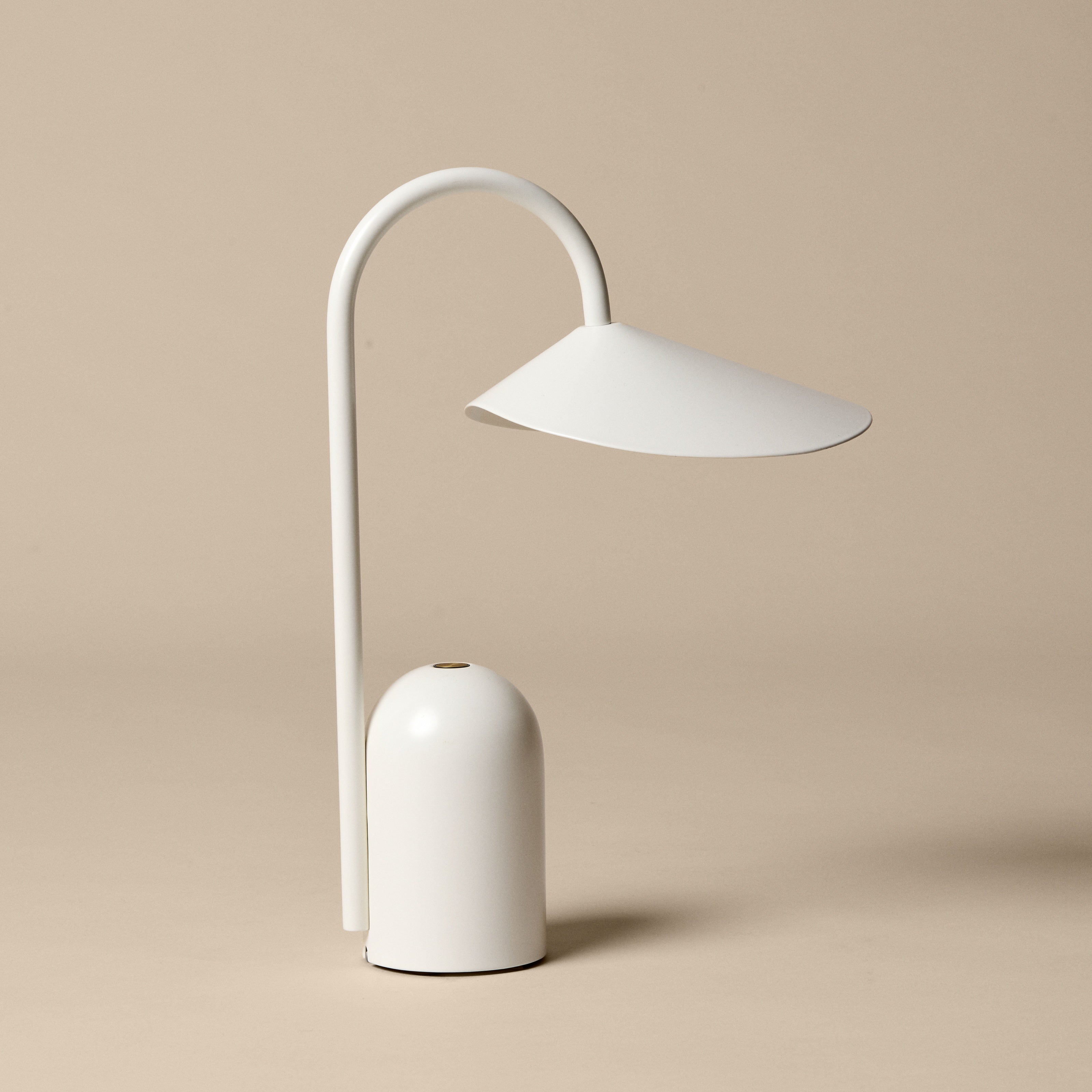 Minimalist white table lamp on a beige background