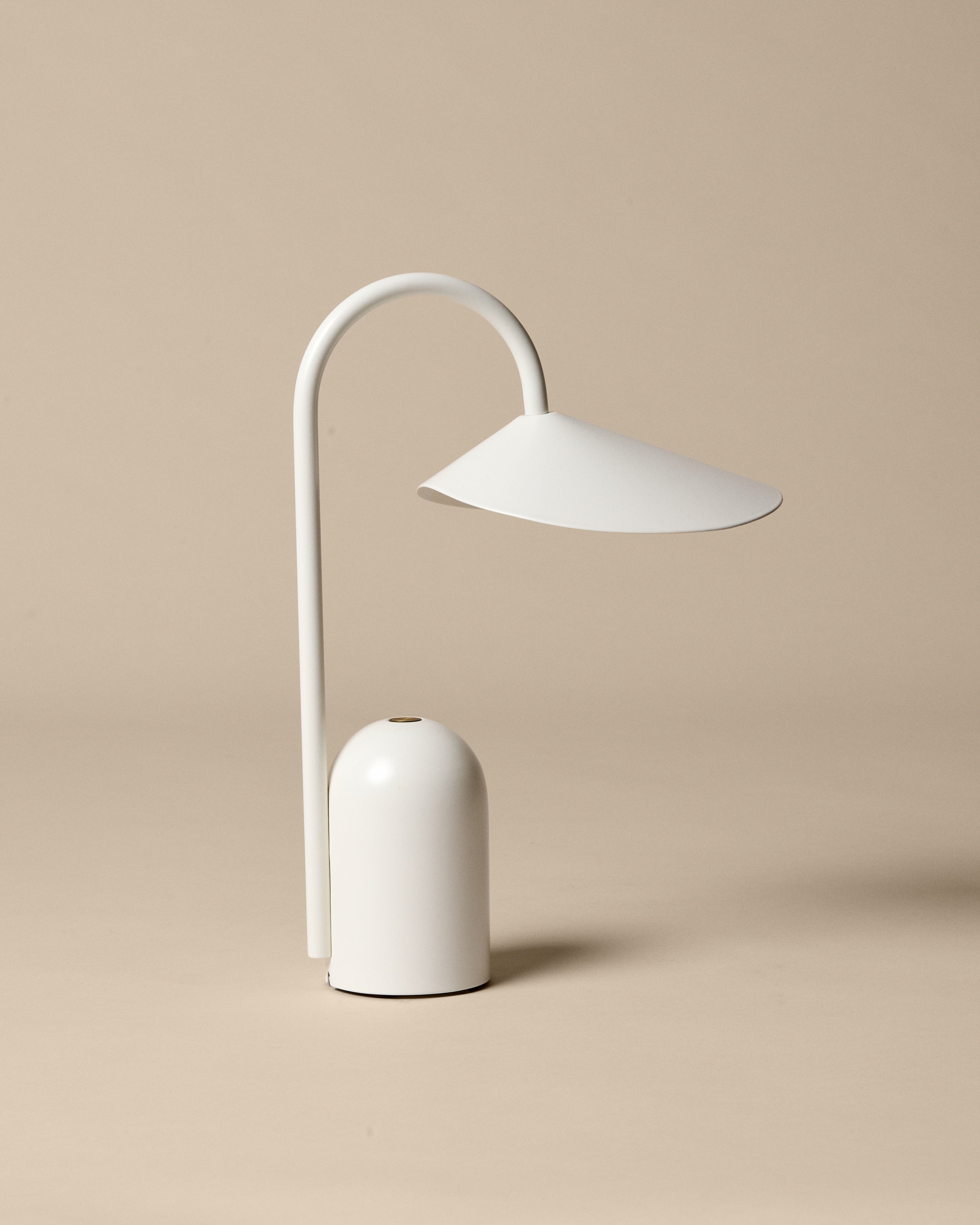 Minimalist white table lamp on a beige background