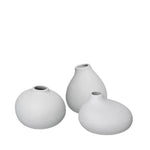 Three light grey ceramic vases of different shapes on a white background