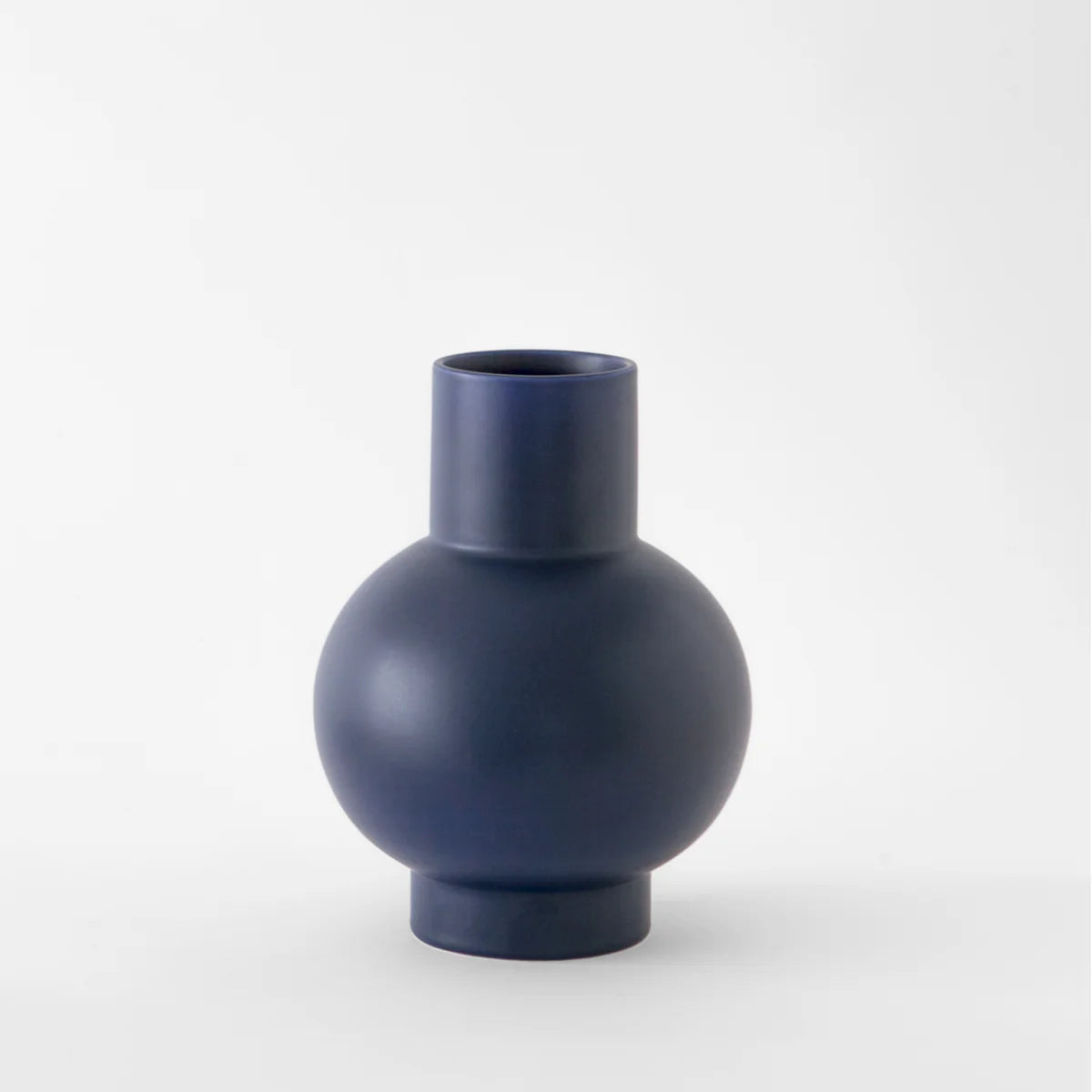 Large navy blue vase on a white background