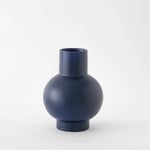 Large navy blue vase on a white background