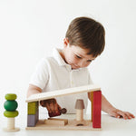 Child playing with a wooden toy on a white background