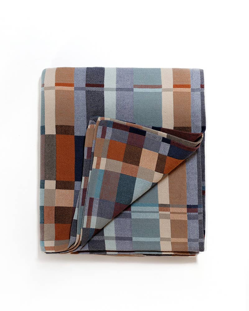 Plaid blanket with a mix of colors on a white background