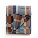 Plaid blanket with a mix of colors on a white background