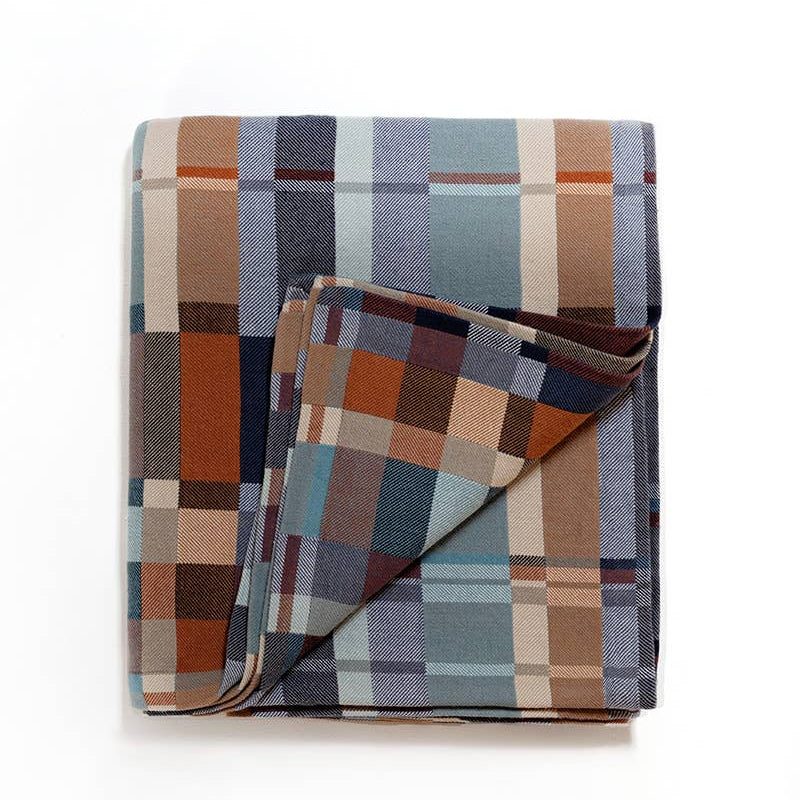 Plaid blanket with a mix of colors on a white background