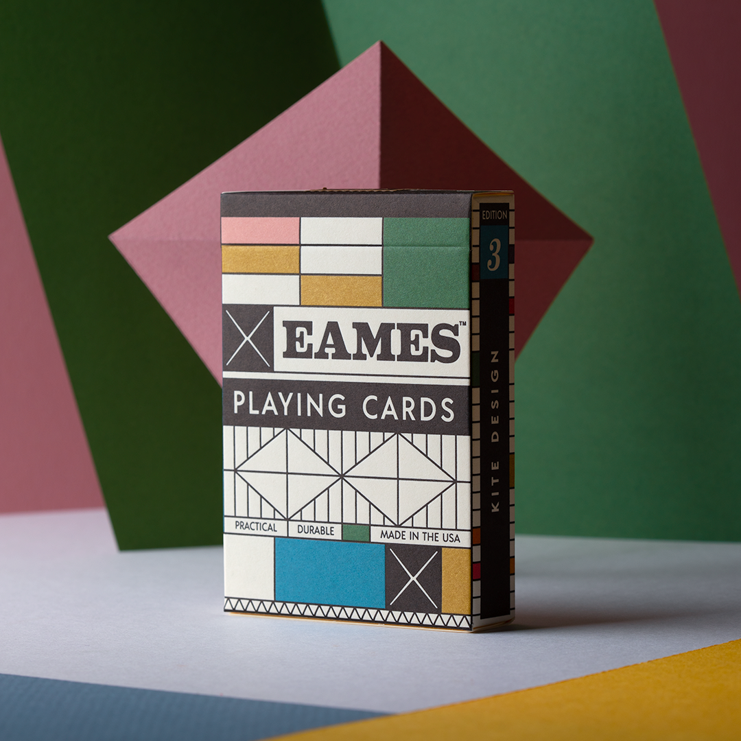 Eames playing cards packaging on a colorful geometric background