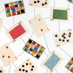 Playing cards with kite-like geometric designs on a white background 