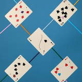 Five playing cards with different suits on a blue background