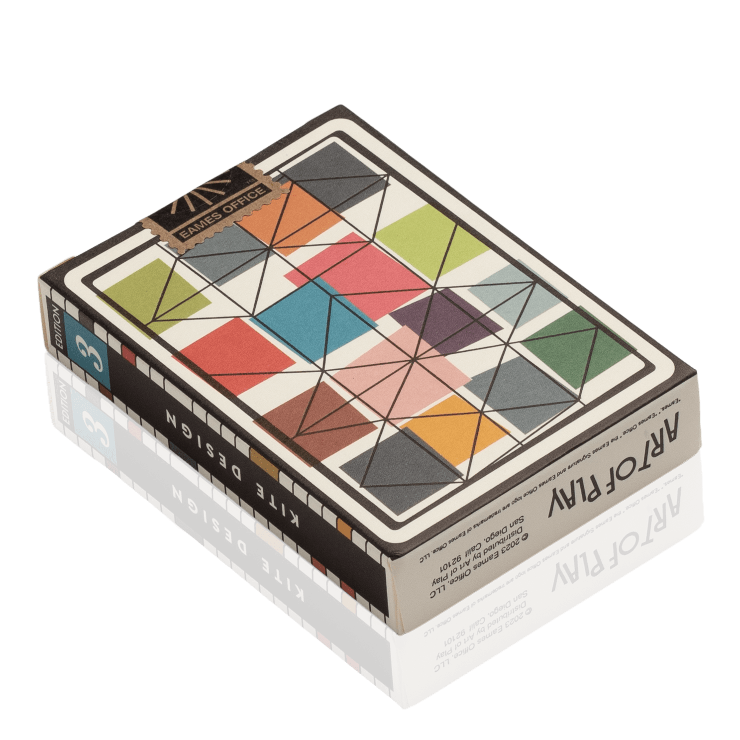 Colorful geometric patterned box for playing cards with Eames Office 'Kite Design' on side of box.