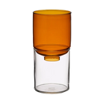 An amber-colored translucent glass vase resting on a clear glass cylinder base, shown against a solid white background.