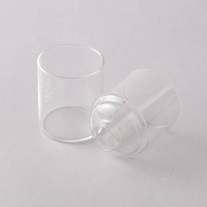Two clear glass cups on a light gray background