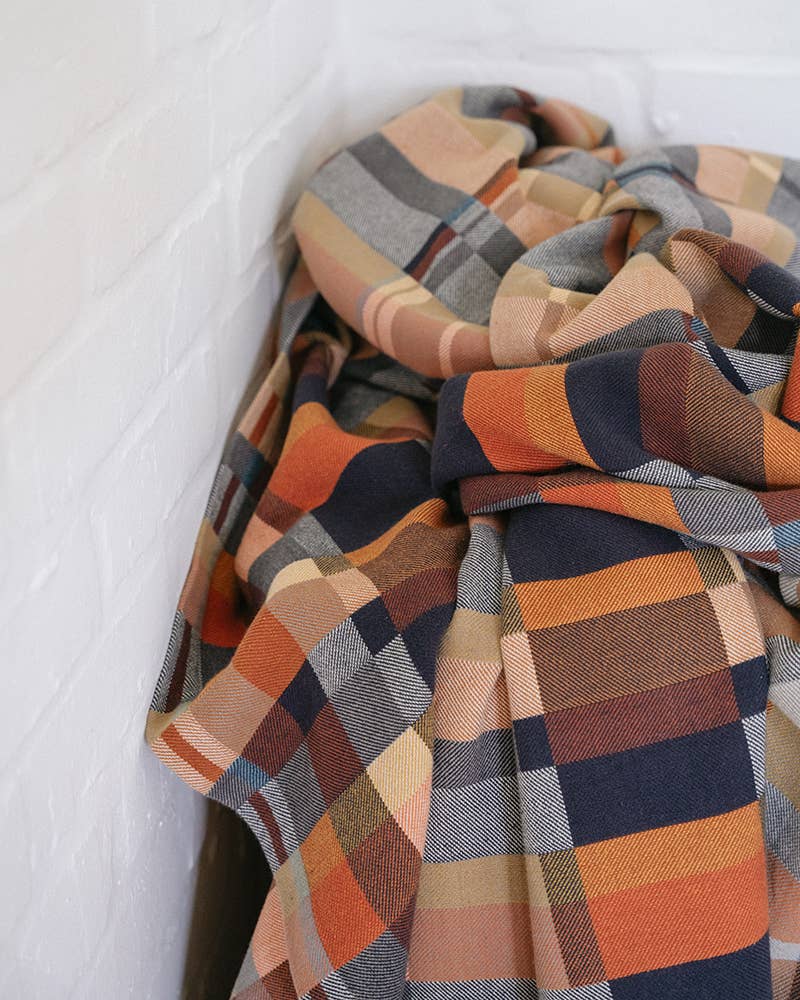 Plaid blanket with autumn colors on a white background